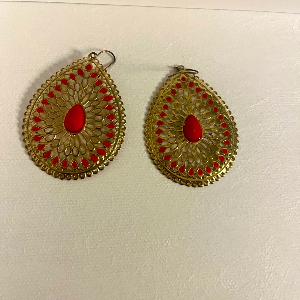 Large gold earrings with orange accents